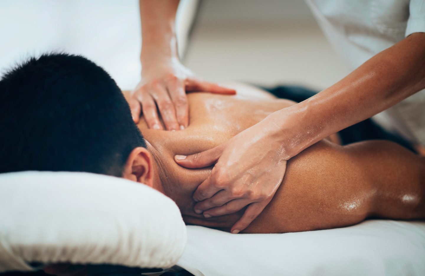 Sports massage. Physical therapist massaging shoulder region